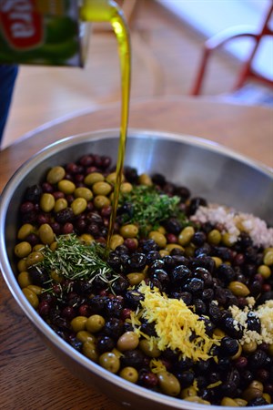 Finishing touches on spiced olives