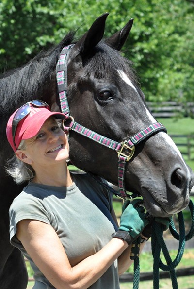 Betsy Hafner Smiling next to a horse