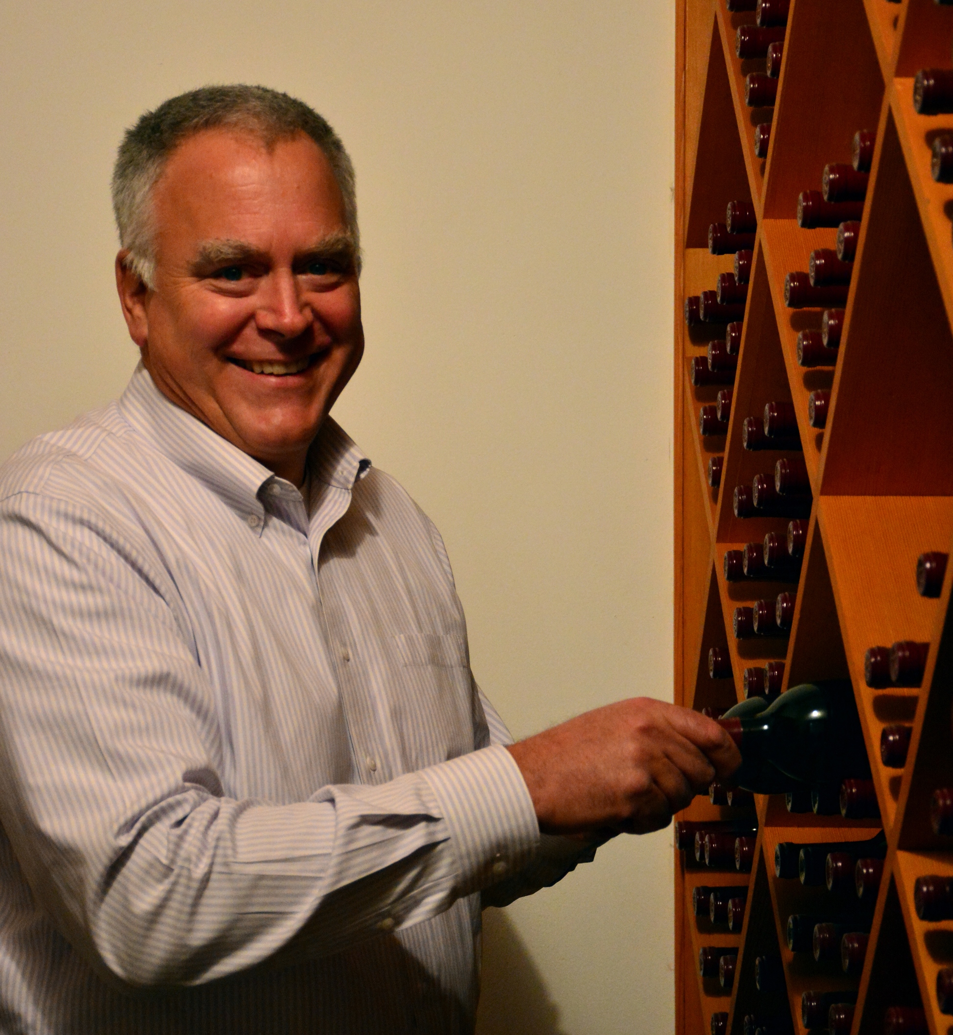 Scott Hafner organizes his wine cellar for the holidays.