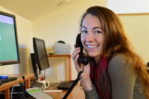 Kate answers a patron's call for holiday orders.