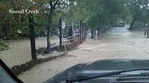 Sausal Creek overflows, rushing across the entrance to Hafner Vineyard.